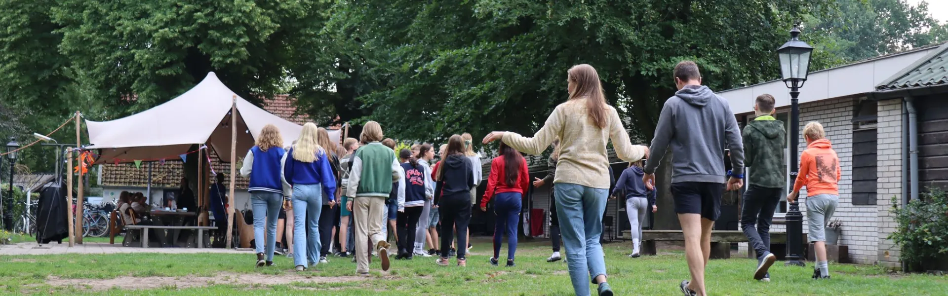 Deelnemers lopen over het terrein op de aankomstdag